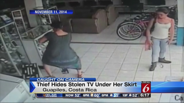 lady steals tv under dress Woman steals flat screen between her legs